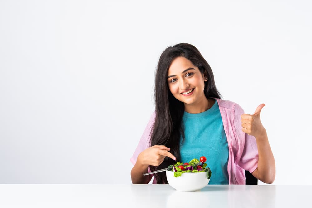 Woman eating salad