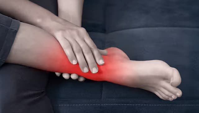 Woman holding ankle